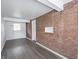 Spacious basement area featuring brick wall, vinyl flooring, and a utility connection at 4029 N Euclid Ave, Indianapolis, IN 46226