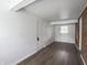 Unfinished basement featuring painted concrete walls, gray vinyl floors, and door to another area at 4029 N Euclid Ave, Indianapolis, IN 46226