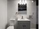 Close-up of the finished basement bathroom featuring a modern gray vanity and comfort-height toilet at 4029 N Euclid Ave, Indianapolis, IN 46226