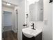 Bathroom with black vanity and faucet next to doorway to bedroom or hallway at 4029 N Euclid Ave, Indianapolis, IN 46226