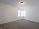Bright bedroom featuring neutral carpet, white walls, and a window with white blinds at 4029 N Euclid Ave, Indianapolis, IN 46226