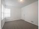 Bright bedroom featuring neutral carpet, white walls, a window with white blinds, and a closet at 4029 N Euclid Ave, Indianapolis, IN 46226