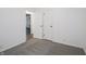 Bedroom featuring neutral carpet, white walls, and a door at 4029 N Euclid Ave, Indianapolis, IN 46226