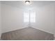 Bright bedroom featuring neutral carpet, white walls, and a window with white blinds at 4029 N Euclid Ave, Indianapolis, IN 46226