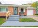 Close-up of a brick ranch home's front porch with freshly painted gray stairs and white columns at 4029 N Euclid Ave, Indianapolis, IN 46226