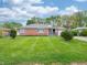 Inviting brick ranch-style house with green lawn, mature trees, and a serene neighborhood setting at 4029 N Euclid Ave, Indianapolis, IN 46226