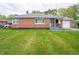 Beautiful brick ranch-style home featuring a lush green lawn and trimmed landscape at 4029 N Euclid Ave, Indianapolis, IN 46226