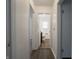 Hallway view leading to a bathroom with wood-look floors and white doors at 4029 N Euclid Ave, Indianapolis, IN 46226