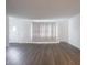 Open living area with wood-look flooring, white walls, and a bright window at 4029 N Euclid Ave, Indianapolis, IN 46226