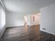 Bright, airy living room with modern gray wood floors and fresh white walls at 4029 N Euclid Ave, Indianapolis, IN 46226