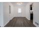 Bright living room with wood-look flooring and a view into the updated kitchen at 4029 N Euclid Ave, Indianapolis, IN 46226