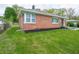 Well-maintained yard of a brick ranch home with a tidy landscape and healthy green grass at 4029 N Euclid Ave, Indianapolis, IN 46226