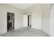 A Primary bedroom with two doorways, carpet, and neutral paint at 4107 Zinfandel Way, Indianapolis, IN 46254