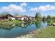 Waterfront property showcasing multiple homes along a calm canal on a beautiful day with blue sky and fluffy white clouds at 4107 Zinfandel Way, Indianapolis, IN 46254