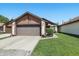 A house showing the garage and well-maintained front yard with green grass at 4107 Zinfandel Way, Indianapolis, IN 46254