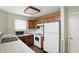 Functional kitchen with wood cabinets, white appliances, and a double-basin sink at 4107 Zinfandel Way, Indianapolis, IN 46254