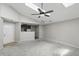 Bright living room with fan, skylight, neutral carpet, and open floor plan at 4107 Zinfandel Way, Indianapolis, IN 46254
