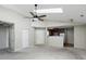 Open living room with fan, skylight, neutral carpet, and view to the kitchen at 4107 Zinfandel Way, Indianapolis, IN 46254