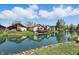 Scenic view of waterfront homes with lush greenery reflecting on the serene lake at 4107 Zinfandel Way, Indianapolis, IN 46254