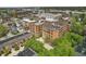 Wide aerial of the building showcasing its location within a neighborhood with mature trees and updated townhomes at 430 N Park Ave # 103, Indianapolis, IN 46202