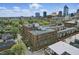 An aerial view of the building featuring a rooftop patio and downtown skyline at 430 N Park Ave # 103, Indianapolis, IN 46202