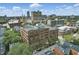 An aerial view of the building and surrounding buildings with a downtown skyline in the background at 430 N Park Ave # 103, Indianapolis, IN 46202