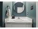 Modern bathroom featuring a white vanity, round mirror, and stylish fixtures at 430 N Park Ave # 103, Indianapolis, IN 46202