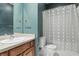 Charming bathroom with a wood vanity with sink and a neutral colored shower curtain at 430 N Park Ave # 103, Indianapolis, IN 46202