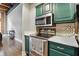 Galley kitchen featuring green cabinets and stainless steel appliances at 430 N Park Ave # 103, Indianapolis, IN 46202