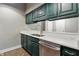 Kitchen featuring sleek counters, stainless steel appliances, and green cabinets at 430 N Park Ave # 103, Indianapolis, IN 46202