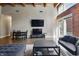 Cozy living room with exposed brick, natural light, and comfortable seating at 430 N Park Ave # 103, Indianapolis, IN 46202