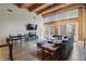 Spacious living room with exposed brick, high ceilings, wood floors, natural light, and a modern design at 430 N Park Ave # 103, Indianapolis, IN 46202