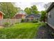 Backyard view with lush lawn, landscaping, and a fenced perimeter at 440 Linden St, Zionsville, IN 46077