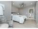 Bright bedroom features a ceiling fan, a bed, and an adjacent seating area with comfortable chair at 440 Linden St, Zionsville, IN 46077