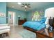 Bright bedroom with blue walls, hardwood floors, and comfortable furnishings at 440 Linden St, Zionsville, IN 46077