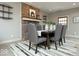 Elegant dining room with brick fireplace, stylish decor, and an area rug on the hardwood floors at 440 Linden St, Zionsville, IN 46077