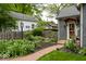 View of the front yard featuring a brick pathway, lush landscaping, and well-maintained lawn at 440 Linden St, Zionsville, IN 46077