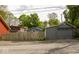 View of a one car detached garage with a wooden fence in front of other houses at 440 Linden St, Zionsville, IN 46077