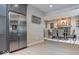 View of stainless steel refrigerator and dining area with table, chairs, and brick fireplace at 440 Linden St, Zionsville, IN 46077