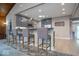 Stylish kitchen bar area with pendant lighting, gray cabinetry, and comfortable barstools at 440 Linden St, Zionsville, IN 46077