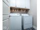 Bright laundry room with white cabinets, washer, and dryer at 440 Linden St, Zionsville, IN 46077