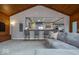 Open concept living space with kitchen view, bar seating, and comfortable gray sofa at 440 Linden St, Zionsville, IN 46077