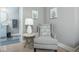 Comfortable chair with side table and lamp situated in a living room near the entryway to the bathroom at 440 Linden St, Zionsville, IN 46077