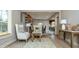 Bright living room with hardwood floors, cozy seating arrangement, and views into dining area at 440 Linden St, Zionsville, IN 46077