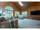 Relaxing sunroom with wood paneling, large windows, comfortable seating, and natural light at 440 Linden St, Zionsville, IN 46077