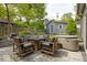 Charming outdoor patio with a fireplace and spa surrounded by mature landscaping and trees at 440 Linden St, Zionsville, IN 46077