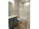 Bright bathroom features a modern vanity with a granite countertop and a shower-tub combination at 4734 Cleome Dr, Plainfield, IN 46168