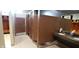 Bathroom with multiple stalls and sinks with a dark stone countertop and tile floors at 4734 Cleome Dr, Plainfield, IN 46168