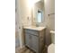Elegant bathroom vanity featuring granite counters, modern fixtures, and a well-lit mirror at 4734 Cleome Dr, Plainfield, IN 46168