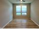 Empty bedroom featuring two windows and wood flooring at 4734 Cleome Dr, Plainfield, IN 46168